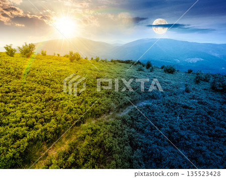 hiking trail through mountain landscape. day and night time change concept. mountains under sky with sun and moon at twilight. scenery with green grass and rolling hills. equality and shift template 135523428