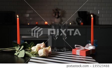The kitchen with burning candles, roses, gift box and empty glasses for Valentines Day The kitchen with burning candles, roses, gift box and empty glasses for Valentines Day 135523488