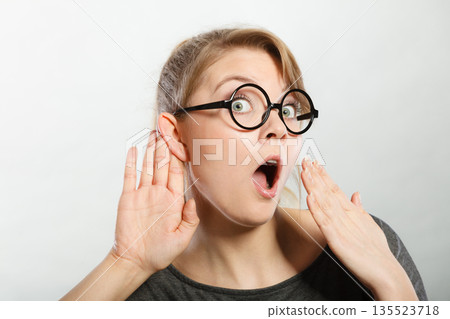 Shocked girl eavesdropping. Shocked girl eavesdropping. 135523718