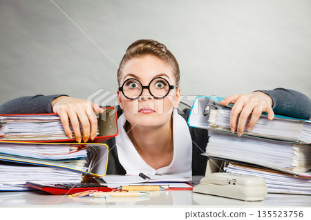 Obsessed female clerk at work. Obsessed female clerk at work. 135523756