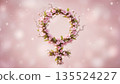 A floral design with pink flowers arranged in the shape of a female symbol, set against a soft background with light spots creating a gentle atmosphere 135524227