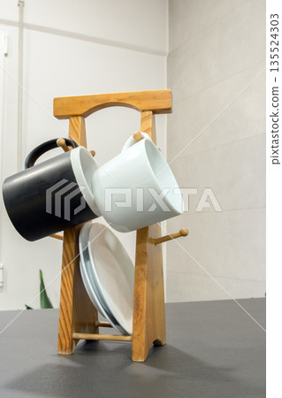 Wooden cup holder with cups and plates Wooden cup holder with cups and plates 135524303