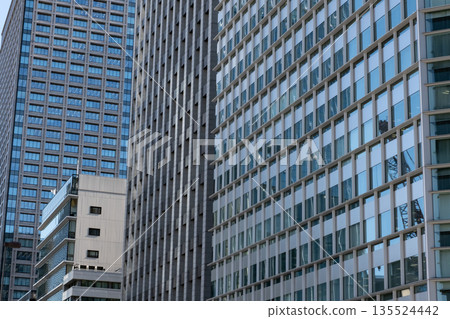 Landscape of the office town looking up at a skyscraper Landscape of the office town looking up at a skyscraper 135524442