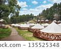 [Material] A luxury Japanese glamping facility with white tents nestled in a lush forest. 135525348