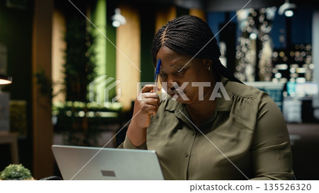 Focused businesswoman reflecting on a business strategy puzzle, envisioning creative concepts and projecting future outcomes. Deep contemplation to inspire new perspective on the problem. Camera B. Focused businesswoman reflecting on a business strategy puzzle, envisioning creative concepts and projecting future outcomes. Deep contemplation to inspire new perspective on the problem. Camera B. 135526320