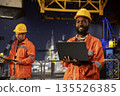 Oil rig platform worker monitoring drilling operations offshore, thinking about risk assessment and efficient natural gas or fossil fuels extraction for the industry. Oil pump and resources. 135526385