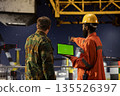 Green screen tablet with soldiers performing escort duty on a maritime vessel near offshore drilling rig, monitoring operations and safeguarding employees from potential security risks. 135526397