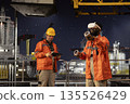 African american engineer with VR goggles supervises offshore drilling operations, using immersive virtual reality equipment for training and maintenance. Safety visualization on oil rig deck. 135526429