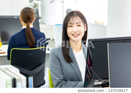 Business woman doing desk work Business woman doing desk work 135526617