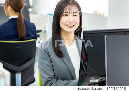 Business woman doing desk work Business woman doing desk work 135526618