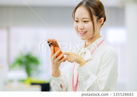 Business woman operating a smartphone 135526681