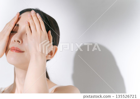 Young woman doing eye skin care 135526721