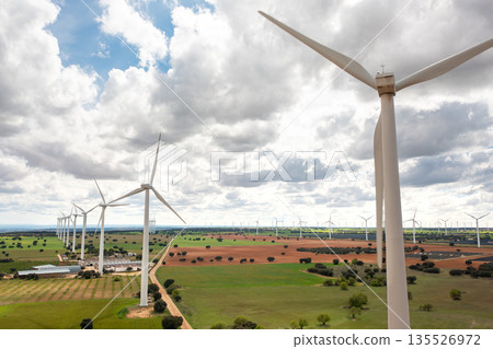 Wind turbines on green farmland generating clean Wind turbines on green farmland generating clean 135526972