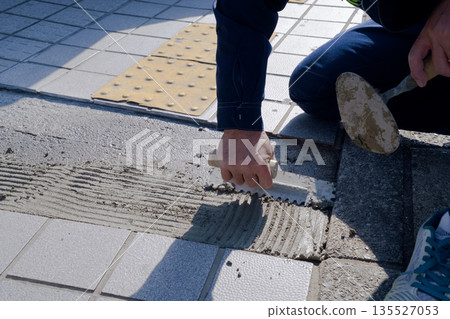 Floor tile installation work in progress - Mortar application status 135527053