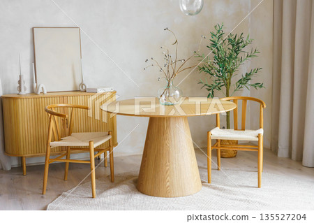 Minimal wooden dining room with round table, bouquet of dried flowers and chairs in modern interior Minimal wooden dining room with round table, bouquet of dried flowers and chairs in modern interior 135527204