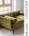 Modern khaki green velvet sofa near large window in stylish living room, loft interior 135527205