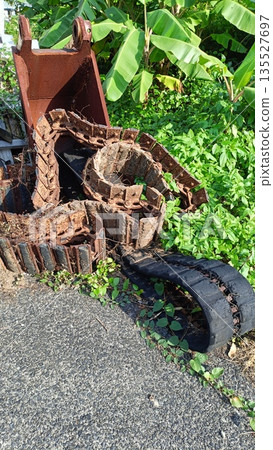 Abandoned caterpillar tracks and heavy machinery buckets Abandoned caterpillar tracks and heavy machinery buckets 135527697