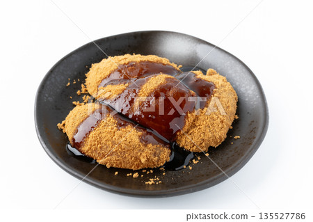 Warabi mochi with brown sugar syrup on a plate on a white background 135527786