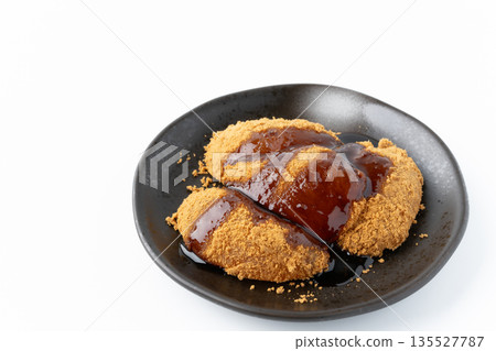Warabi mochi with brown sugar syrup on a plate on a white background 135527787