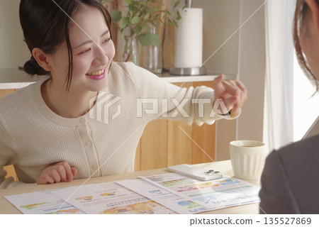 A young woman consulting about insurance and asset formation A young woman consulting about insurance and asset formation 135527869