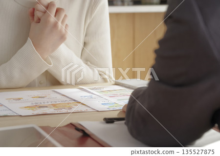 A young woman consulting about insurance and asset formation A young woman consulting about insurance and asset formation 135527875