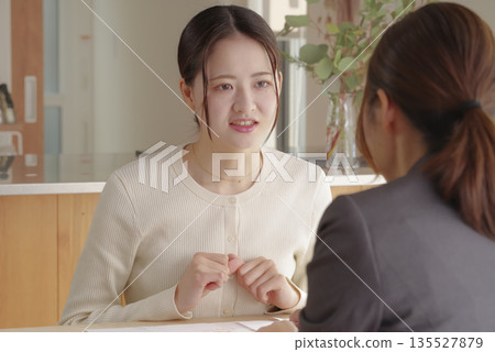 A young woman consulting about insurance and asset formation A young woman consulting about insurance and asset formation 135527879