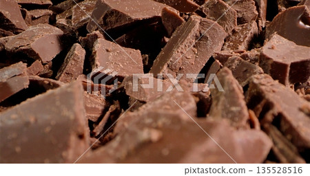 Chunks Of Dark Cocoa Against Textured Surface, Fragmented Chocolate On Rough Background With Inviting Aroma 135528516