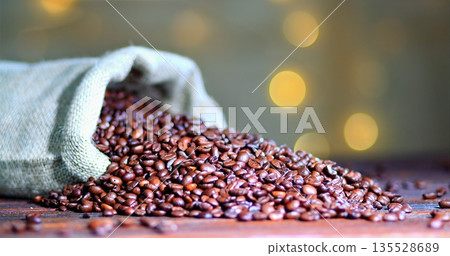 Roasted Beans From Sack, Artisan Small Batch Roast Captured With Warm Glow And Textured Table Surface Roasted Beans From Sack, Artisan Small Batch Roast Captured With Warm Glow And Textured Table Surface 135528689