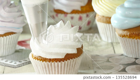 Sweet Frosting Moment, Artistic Scene Of Cupcake Decoration Showcasing Piping Skills And Soft Pastel Colors Sweet Frosting Moment, Artistic Scene Of Cupcake Decoration Showcasing Piping Skills And Soft Pastel Colors 135528694