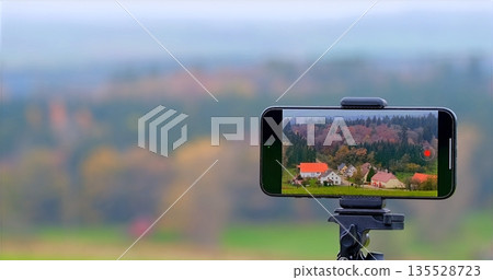 Vivid Rural Landscape, Setup Designed To Shoot Tranquil Countryside Scenes Using Smartphone And Tripod Vivid Rural Landscape, Setup Designed To Shoot Tranquil Countryside Scenes Using Smartphone And Tripod 135528723
