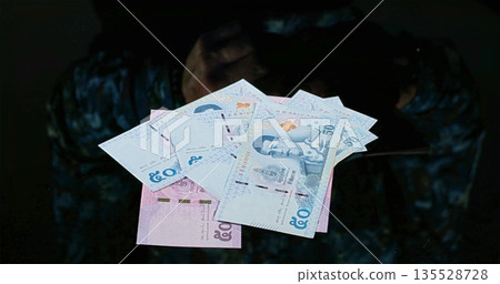 Secret Money Exchange, Unseen Individual Engaged In Secret Banknote Swapping Under Dim Illumination Secret Money Exchange, Unseen Individual Engaged In Secret Banknote Swapping Under Dim Illumination 135528728