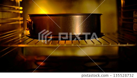 Oven Radiates Cozy Dessert Warmth, Gentle Steam And Glowing Heat Create Inviting Kitchen Ambiance 135528732