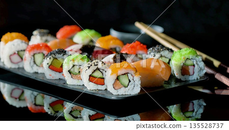 Assorted Sushi Platter With Colorful Varieties, Brightly Arranged Assortment Of Sushi With Accompaniments Assorted Sushi Platter With Colorful Varieties, Brightly Arranged Assortment Of Sushi With Accompaniments 135528737