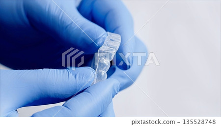 Detailed Inspection Of Transparent Dental Device By Technician Ensuring Product Safety And Delivery Readiness Detailed Inspection Of Transparent Dental Device By Technician Ensuring Product Safety And Delivery Readiness 135528748