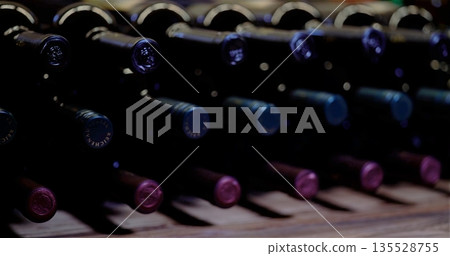 Rustic Wooden Shelf Holding Antique Wine Bottles With Soft Atmospheric Lighting And Blurred Background Rustic Wooden Shelf Holding Antique Wine Bottles With Soft Atmospheric Lighting And Blurred Background 135528755