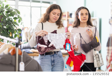 Two girls spend time in shop and choose lingerie 135529332