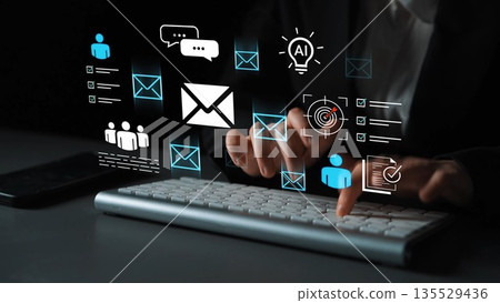 Hands typing on a keyboard with glowing icons representing digital communication, technology, and artificial intelligence interactions in a dark setting Gluon Hands typing on a keyboard with glowing icons representing digital communication, technology, and artificial intelligence interactions in a dark setting Gluon 135529436