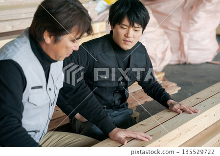 Two men working in a lumberyard Two men working in a lumberyard 135529722