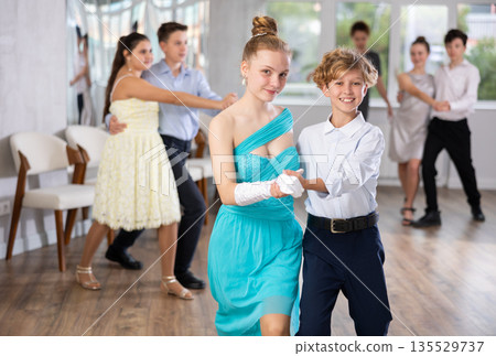 Teenage students rehearsing ballroom dance while preparing for college festive event 135529737