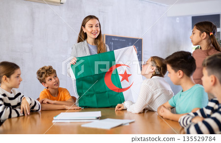 Teacher with flag of Algeria tells story of the emergence of state Teacher with flag of Algeria tells story of the emergence of state 135529784