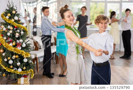 Teenage students rehearsing ballroom dance number for upcoming Christmas party 135529790