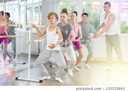 Teenage boy practicing plie position of ballet choreography classes Teenage boy practicing plie position of ballet choreography classes 135529841