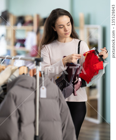 Girl spend time in shop and choose lingerie Girl spend time in shop and choose lingerie 135529843