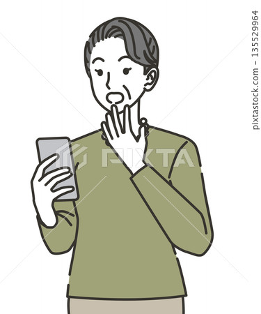 Senior woman surprised to see a smartphone Senior woman surprised to see a smartphone 135529964