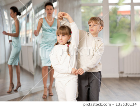 Boy with pair girl in sport wear train to dance contemporary vigorous hustle during classes. Boy with pair girl in sport wear train to dance contemporary vigorous hustle during classes. 135530134