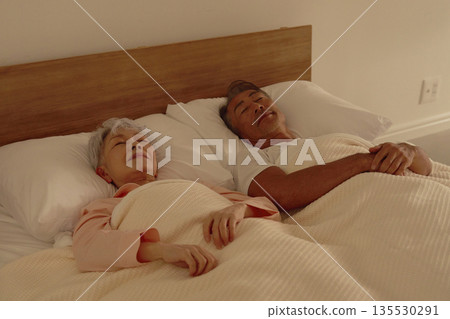Senior couple sleeping in their bedroom Senior couple sleeping in their bedroom 135530291