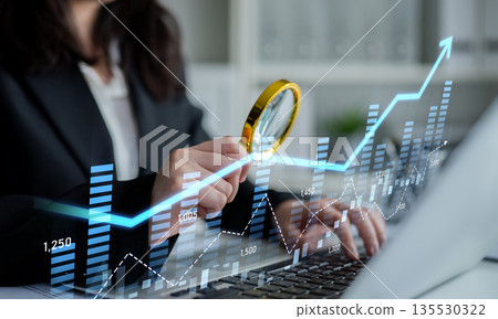 Business professional analyzing growth charts with magnifying glass, modern office background, digital data visualization and investment trends, stock market analysis Scalp Business professional analyzing growth charts with magnifying glass, modern office background, digital data visualization and investment trends, stock market analysis Scalp 135530322