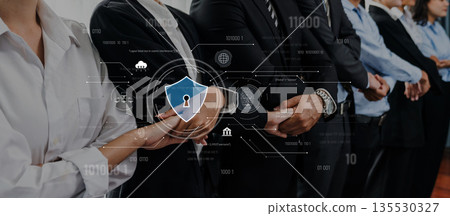 Group of Business Professionals Collaborating on Security Solutions with Digital Interface Displaying Data Protection Concepts and Insights Trope 135530327