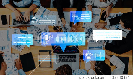 Team Collaboration with Artificial Intelligence Tools and Data Analysis on a Conference Table Surrounded by Laptops and Reports Gluon Team Collaboration with Artificial Intelligence Tools and Data Analysis on a Conference Table Surrounded by Laptops and Reports Gluon 135530335