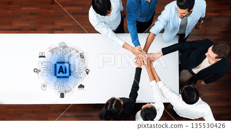 Diverse group of professionals collaborating in a meeting around a table with AI technology symbol in the center, showcasing teamwork and innovation in modern workplace Trope Diverse group of professionals collaborating in a meeting around a table with AI technology symbol in the center, showcasing teamwork and innovation in modern workplace Trope 135530426